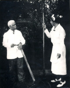 Isaac and Mary Scott holding garden tools in a garden