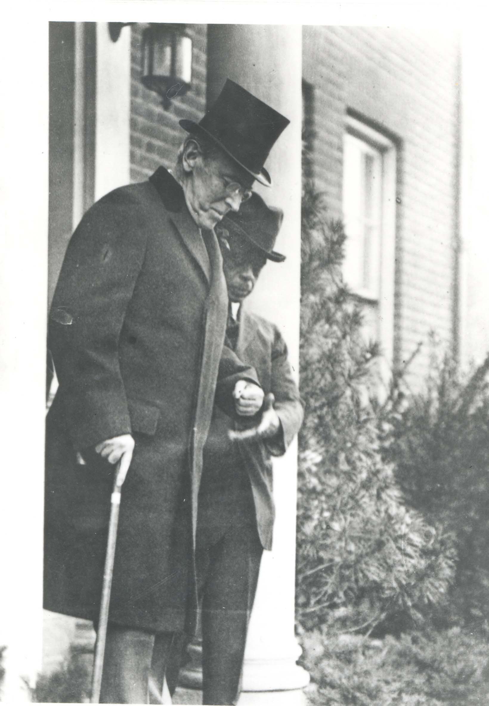 Woodrow Wilson with Isaac Scott in front of S Street home.