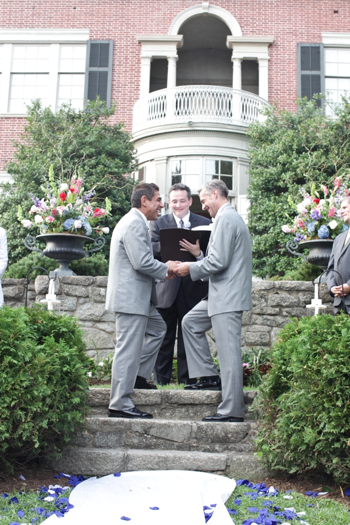 Two people getting married on the steps of the lower garden